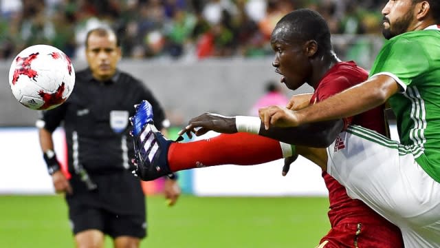Mexico defender Hedgardo Marin, right, kicks the ball as Ghana forward Raphael Dwamena in 2017.