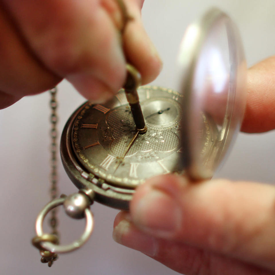 Mike Conroy - owner of Ye Old Watch shop in Portsmouth, Va. winds an antique Fusee pocket watch.