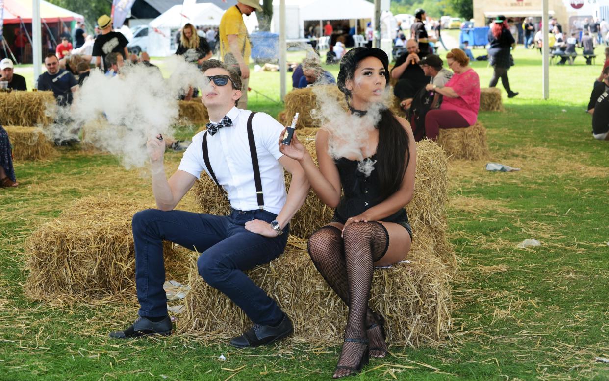 A young couple vaping at a festival in Shrewsbury - Copyright (c) 2015 Rex Features. No use without permission.