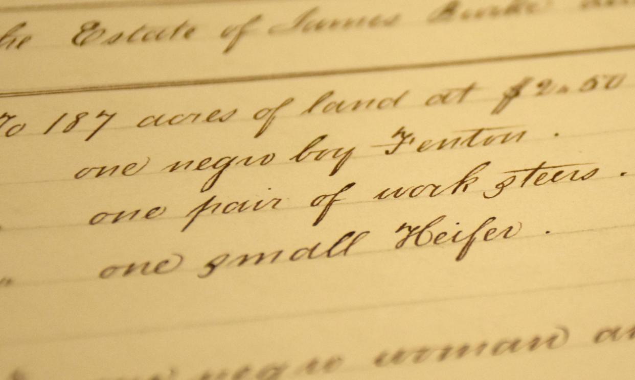 <span>A ledger reading, at center, ‘one negro boy Fenton’, that David Martosko found in his research of Silas Burke.</span><span>Photograph: David Martosko</span>