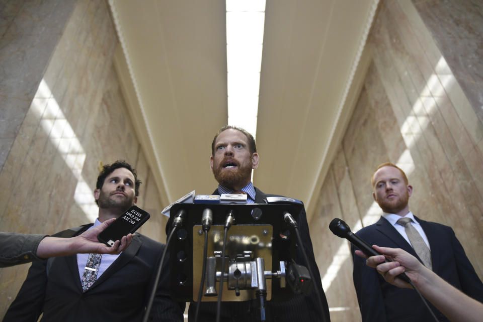 Attorneys Curtis Briggs, center, and Tyler Smith, left, who represent Max Harris, speak to the media at Alameda County Courthouse in Oakland, Calif., Tuesday April, 30, 2019. Two defendants, Derick Almena and Harris are standing trial on charges of involuntary manslaughter after a 2016 fire killed 36 people at a warehouse party they hosted in Oakland. (AP Photo/Cody Glenn)