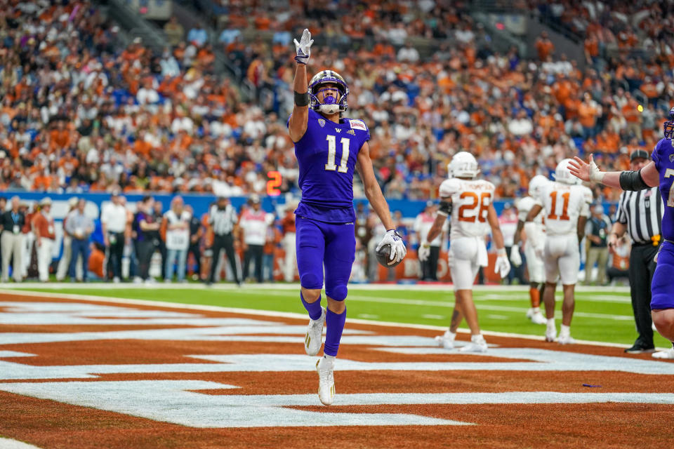 Dec 29, 2022; San Antonio, Texas, USA; Washington Huskies wide receiver Jalen McMillan (11) celebrates a touchdown catch against the <a class="link " href="https://sports.yahoo.com/ncaaw/teams/texas/" data-i13n="sec:content-canvas;subsec:anchor_text;elm:context_link" data-ylk="slk:Texas Longhorns;sec:content-canvas;subsec:anchor_text;elm:context_link;itc:0">Texas Longhorns</a> in the 2022 Alamo Bowl at the Alamodome. Mandatory Credit: Daniel Dunn-USA TODAY Sports