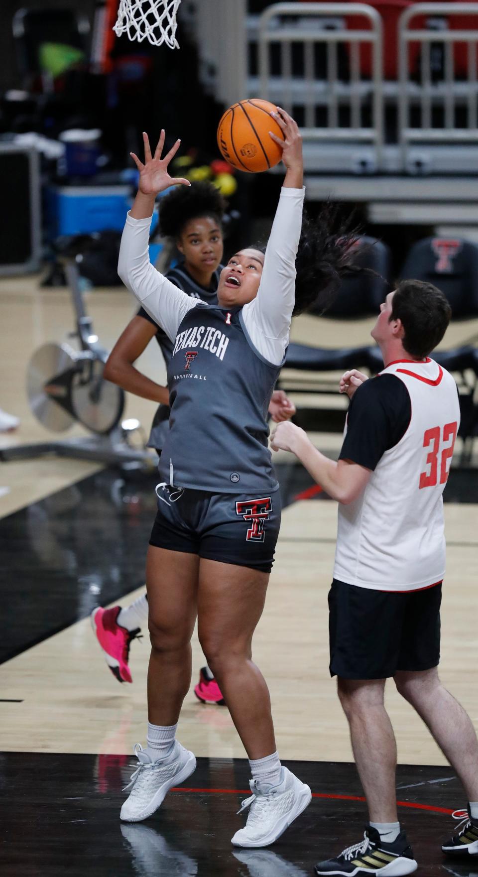 Texas Tech's Ella Tofaeono, center, pulls in a rebound on the first day of practice, Monday, Sept. 26, 2022, at United Supermarkets Arena in Lubbock.