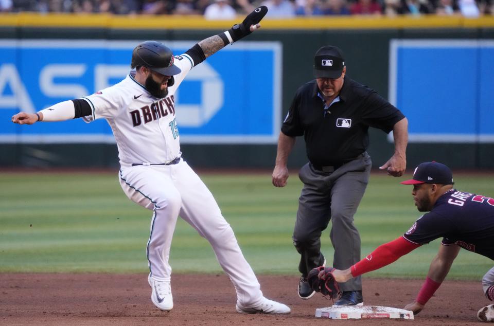 May 6, 2023; Phoenix, AZ, USA; Arizona Diamondbacks’ Emmanuel Rivera (15) sneaks a foot in safely past the tag of Washington Nationals infielder Luis García (2) at Chase Field. 