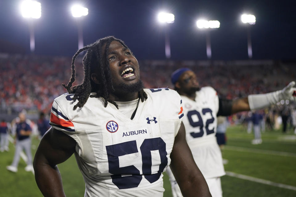 Auburn defensive lineman Marcus Harris (50) celebrates the team's win against Vanderbilt after an NCAA college football game Saturday, Nov. 4, 2023, in Nashville, Tenn. (AP Photo/George Walker IV)