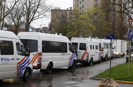 Police vehicles gather in Anderlect after fugitive Mohamed Abrini was arrested in a suburb of Brussels, Belgium, April 8, 2016. REUTERS/Yves Herman