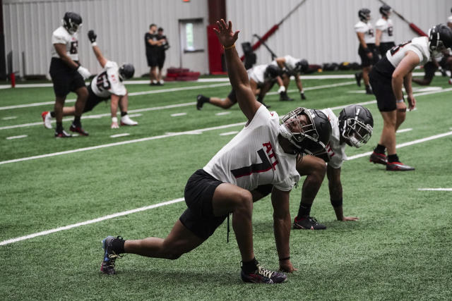 Atlanta Falcons rookie running back Bijan Robinson (7) stretches during the NFL football team's rookie minicamp Friday, May 12, 2023, in Flowery Branch, Ga. (AP Photo/John Bazemore)