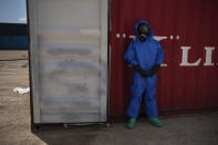 A French emergency worker, part of a special unit working with chemicals, stands next to a shipping container storing flammable liquids, at the site of last week's explosion, in the port of Beirut, Lebanon, Monday, Aug. 10, 2020. The unit is identifying potential leaks and securing an area where containers with flammable liquids have been damaged by the blast. (AP Photo/Felipe Dana)