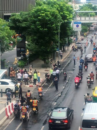 A crowd gathers near the site where explosions were heard in Bangkok