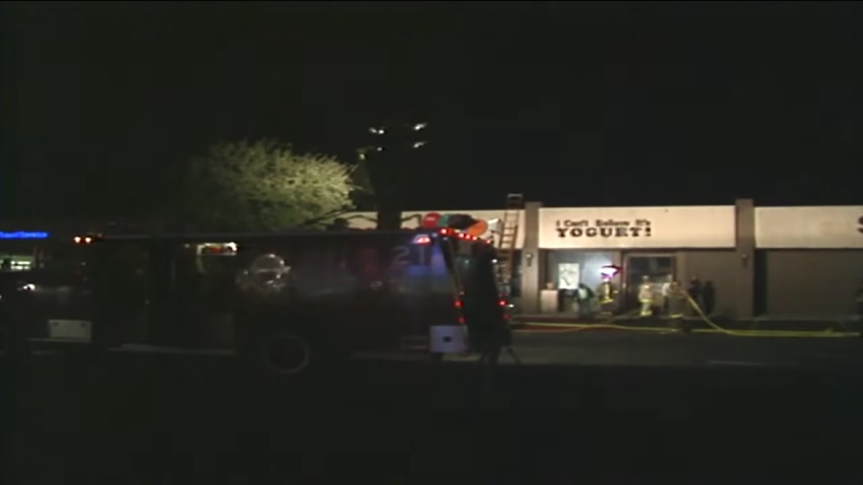 A truck in front of a yogurt shop