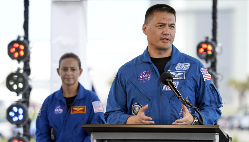 NASA astronaut Kjell Lindgren, right, answers a question during a countdown clock briefing for the SpaceX Demo-2 mission Friday, May 29, 2020, at Kennedy Space Center in Cape Canaveral, Fla. The Falcon 9, with the Crew Dragon spacecraft on top of the rocket, is scheduled to liftoff from Launch Pad 39-A Saturday. Two astronauts will fly on the mission to the International Space Station. (AP Photo/David J. Phillip)