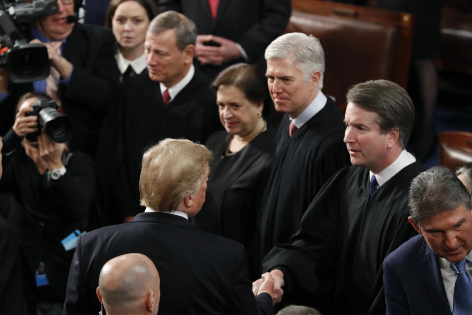 President Donald Trump shakes hands with Supreme Court Justice Brett Kavanaugh, after delivering his State of the Union address to a joint session of Congress on Capitol Hill in Washington, Tuesday, Feb. 5, 2019. Watching are from left, Supreme Court Chief Justice John Roberts, Associate Justice Elena Kagan and Associate Justice Neil Gorsuch. (AP Photo/J. Scott Applewhite)