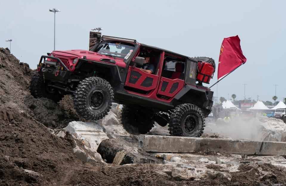 A Jeep takes on the obstacle course at Daytona International Speedway at Jeep Beach 2023. Across International Speedway Boulevard, the One Daytona dining, entertainment and retail complex offers an array of diversions.