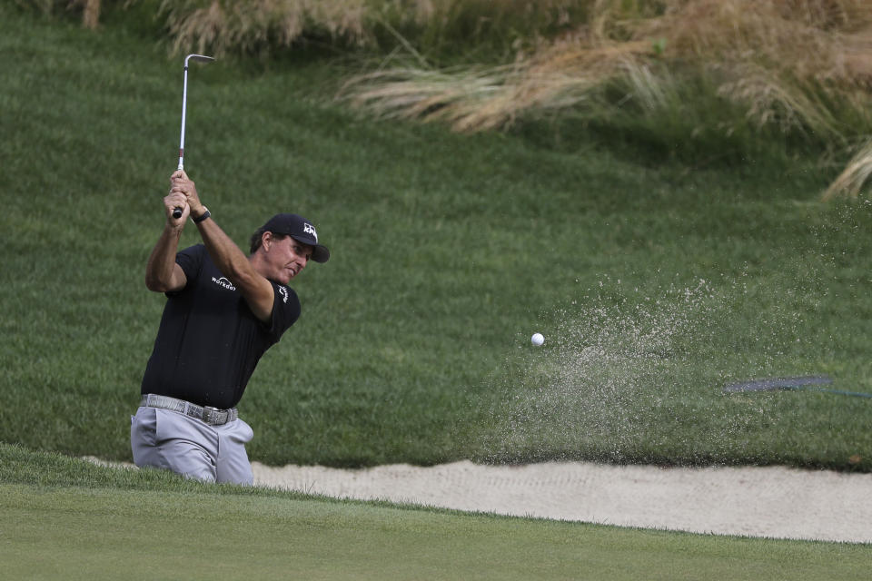 Phil Mickelson hits out of a sand trap on the 16th hole during the first round of the Travelers Championship golf tournament at TPC River Highlands, Thursday, June 25, 2020, in Cromwell, Conn. (AP Photo/Frank Franklin II)