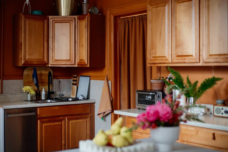 Rust curtain hung in rust painted kitchen.