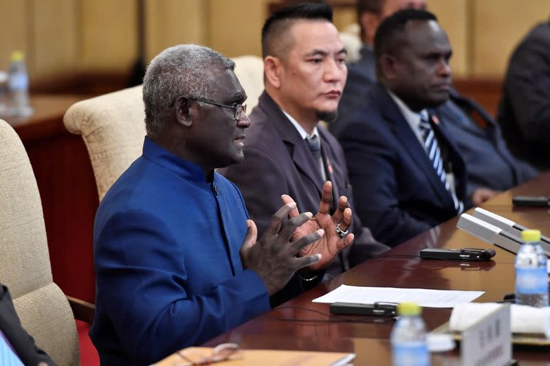 FILE PHOTO: Solomon Islands Prime Minister Manasseh Sogavare talks to Chinese President Xi Jinping during their meeting at the Diaoyutai State Guesthouse in Beijing