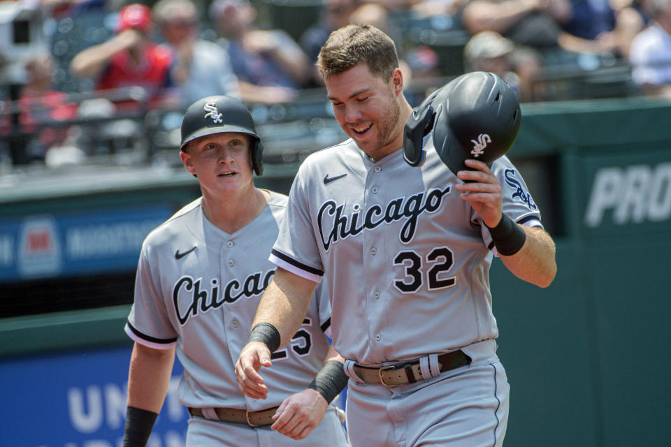 Chicago White Sox' Gavin Sheets, foreground, and Andrew Vaughn, rear, walk to the dugout after scoring on a double by Romy Gonzalez during the fourth inning of a baseball game against the Cleveland Guardians in Cleveland, Wednesday, May 24, 2023. (AP Photo/Phil Long)