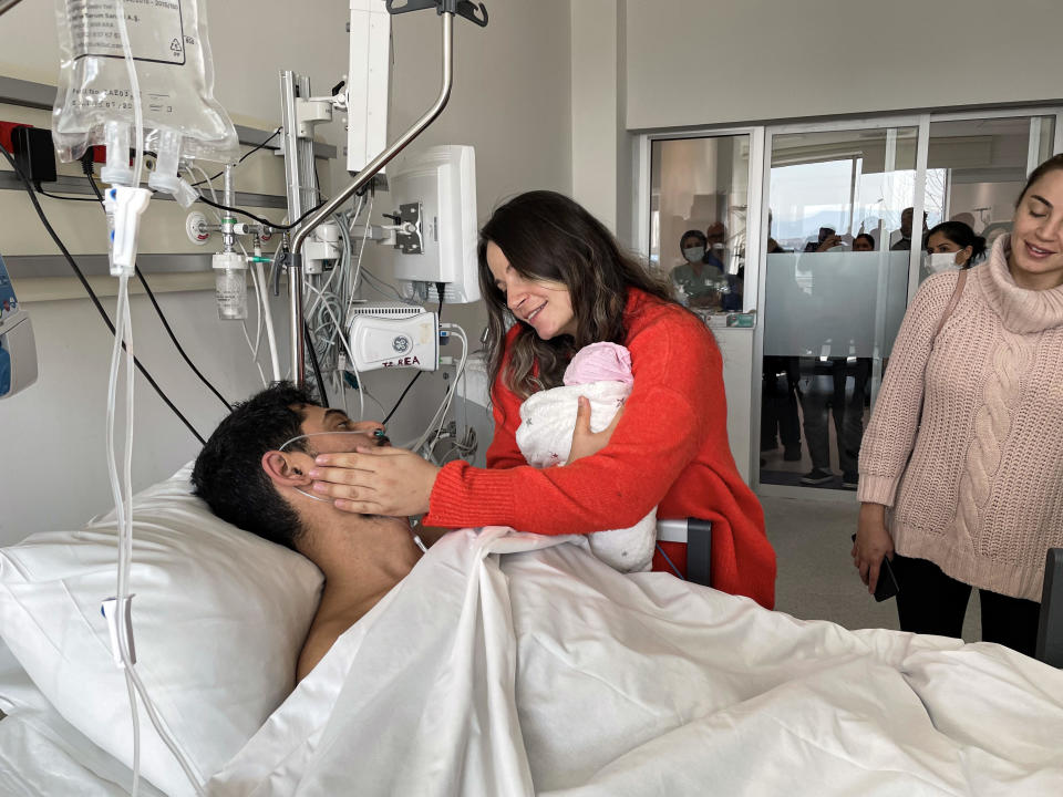 Mustafa Avci, a man rescued from earthquake rubble after 261 hours in Antakya, Turkey, meets his 12-day-old baby at the hospital where he's being treated, February 17, 2023. / Credit: Sezgin Pancar/Anadolu Agency/Getty