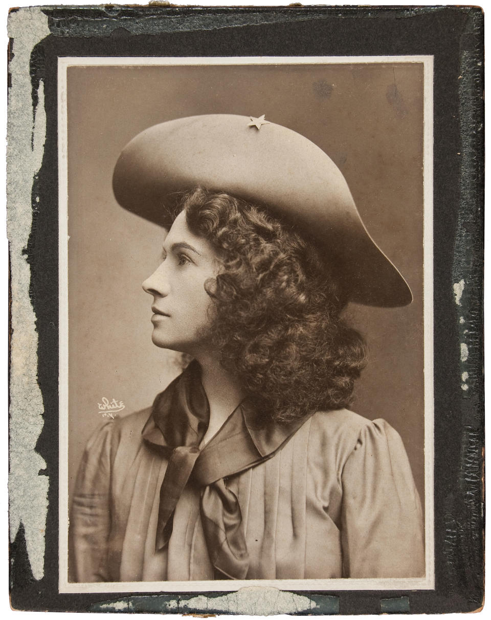 This handout photo, provided by Heritage Auctions, shows Annie Oakley in one of her cabinet photos. Oakley wears the dark wig she wore for The Western Girl was taken in New York between 1902 and 1904. Relatives of Oakley are selling items that once belonged to the legendary sharpshooter including a Stetson hat, guns, letters and photographs. Heritage Auctions will offer up about 100 items related to Oakley on Sunday in Dallas.(AP Photo/Courtesy of Heritage Auctions)