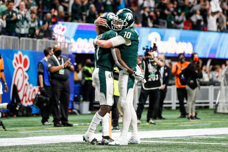 Michigan State wide receiver Jayden Reed, left, celebrates a touchdown with quarterback Payton Thorne during the second half of the 31-21 win over Pittsburgh in the Peach Bowl at the Mercedes-Benz Stadium in Atlanta on Thursday, Dec. 30, 2021.