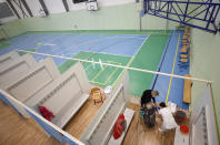 An elderly woman receives Moderna COVID-19 vaccine at a sports hall in Ricany, Czech Republic, Friday, Feb. 26, 2021. With new infections soaring due to a highly contagious coronavirus variant and hospitals filling up, one of the hardest-hit countries in the European Union is facing inevitable: a tighter lockdown. (AP Photo/Petr David Josek)