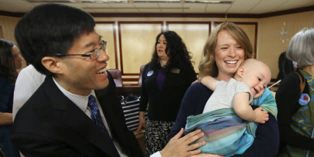 Sen Richard Pan, D-Sacramento, left, talks with Jennifer Wonnacott, a supporter of Pan's measure requiring California schoolchildren to get vaccinated, after the bill was approved by the Senate, at the Capitol in Sacramento, Calif., Thursday May 14, 2015. Wonnacott is holding her son Gavin, 11 months.  The bill, SB277, co-authored by Sen. Ben Allen, D-Santa Monica, was approved by a 25-10 vote and sent to the Assembly. (AP Photo/Rich Pedroncelli) (Photo: )