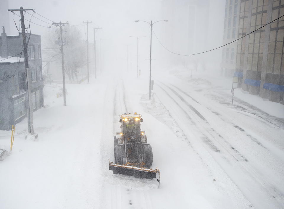 A snow plow clears a path through the snow in St. John‚ Newfoundland on Friday, Jan. 17, 2020. The city has declared a state of emergency, ordering businesses closed and vehicles off the roads as blizzard conditions descend on the Newfoundland and Labrador capital. *Andrew Vaughan/The Canadian Press via AP)