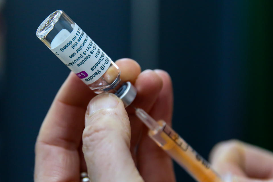 UNITED KINGDOM - 2021/03/19: A NHS staff member holding the Oxford AstraZeneca Covid-19 vaccine vial with a syringe. (Photo by Dinendra Haria/SOPA Images/LightRocket via Getty Images)