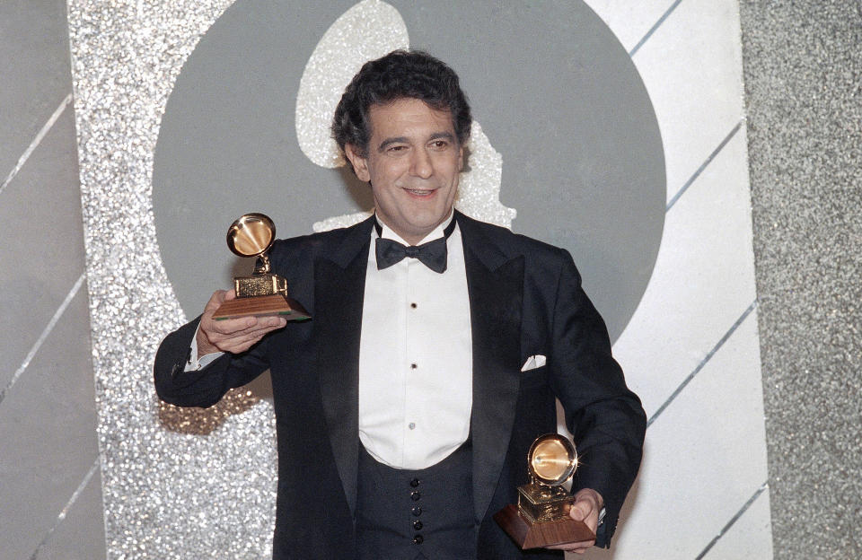 ARCHIVO - En esta imagen de archivo del 26 de febrero de 1985, Plácido Domingo sostiene sus dos trofeos durante la ceremonia de los Premios Grammy. (AP Foto/Archivo)