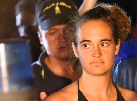 FILE PHOTO: Sea-Watch 3 captain Carola Rackete is escorted off the ship by police and taken away for questioning, in Lampedusa