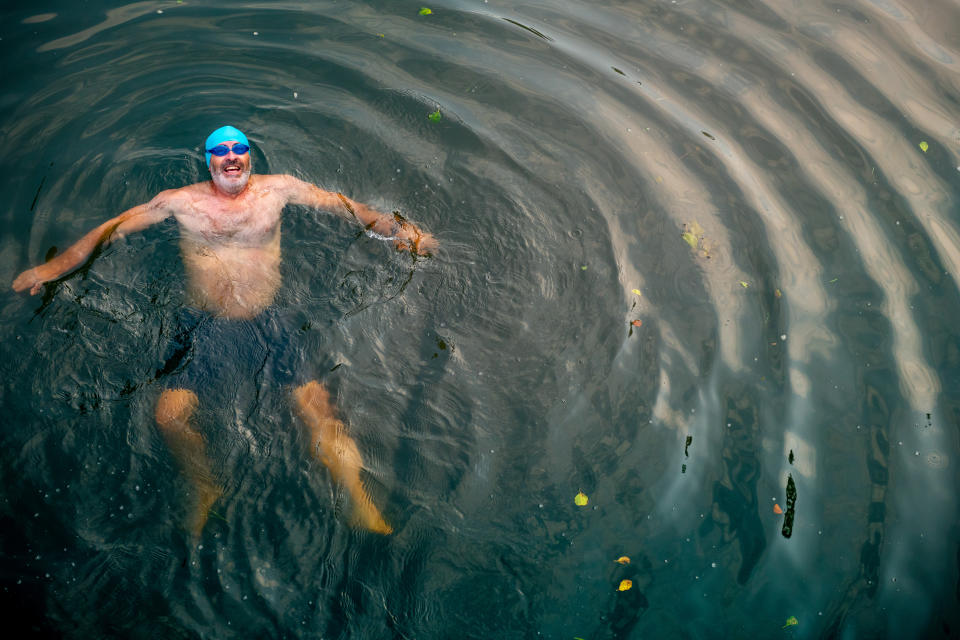 man swimming in a river