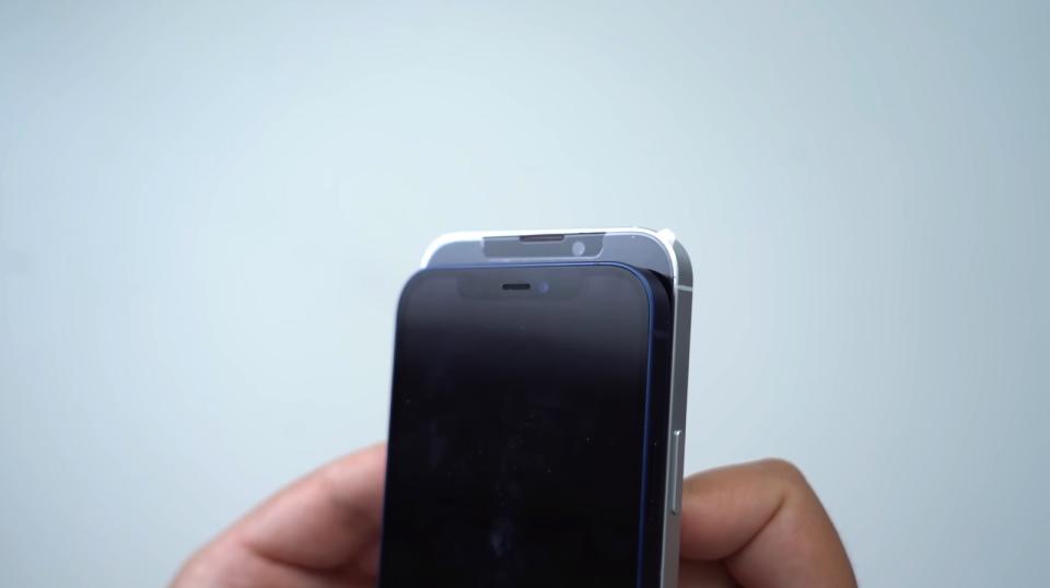 iPhone 13 dummy unit with speaker in top bezel (background) vs. iPhone 12 (foreground). - Credit: MacRumors