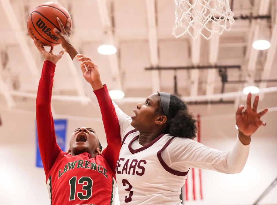 Lawrence Central Bears Lola Lampley (3) reaches for the ball against Lawrence North Wildcats Naja Winston (13) on Thursday, Dec. 7, 2023, during the game at Lawrence Central High School in Indianapolis. The Lawrence Central Bears defeated the Lawrence North Wildcats, 57-55.