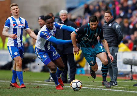 Soccer Football - FA Cup Quarter Final - Wigan Athletic vs Southampton - DW Stadium, Wigan, Britain - March 18, 2018 Southampton's Shane Long in action with Wigan Athletic’s Cheyenne Dunkley REUTERS/Phil Noble