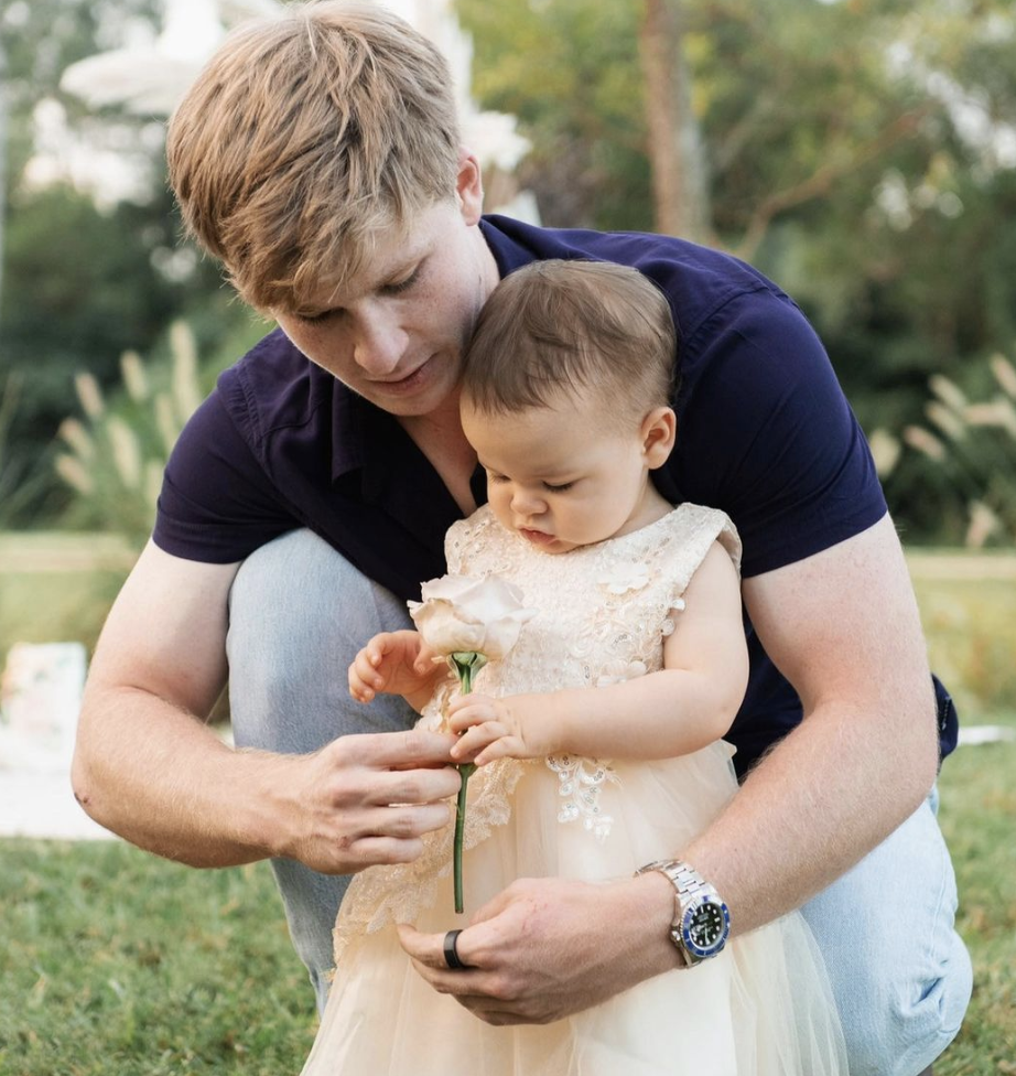 Robert Irwin shows Bindi Irwin's daughter Grace a flower in Australia