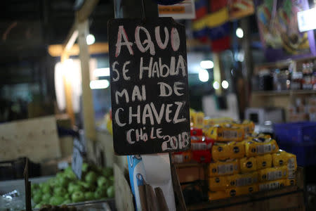 A banner that reads, "Here we talk ill of Chavez" is seen in La Vega market in Santiago, Chile, May 10, 2018. REUTERS/Ivan Alvarado