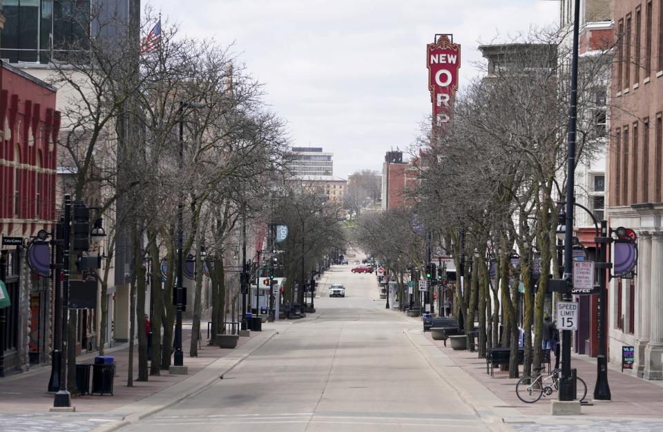 In this Wednesday April 15, 2020, photo, State Street is mostly empty around noontime due to the coronavirus pandemic in Madison, Wis.