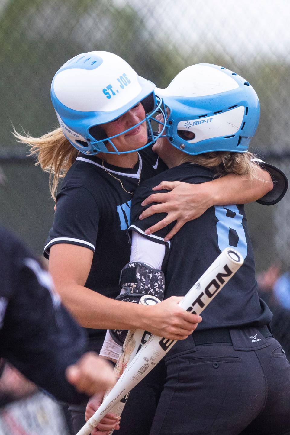 Saint Joseph's Riley Zache (8) gets a hug from Berkley Zache (19) after hitting a home run during the Penn vs. Saint Joseph softball game Monday, May 8, 2023 at the Northside Athletic Complex in South Bend.