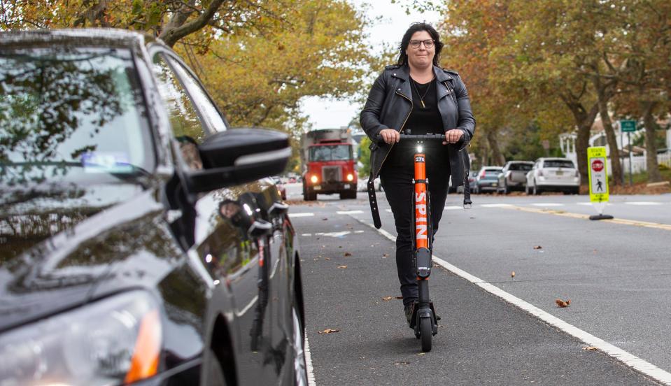 Jess Alaimo rides an e-scooter on her way to work in downtown Asbury Park.