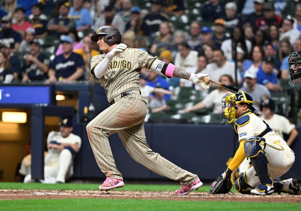 Third base Manny Machado gets a hit during the Padres' big fifth inning Monday night.