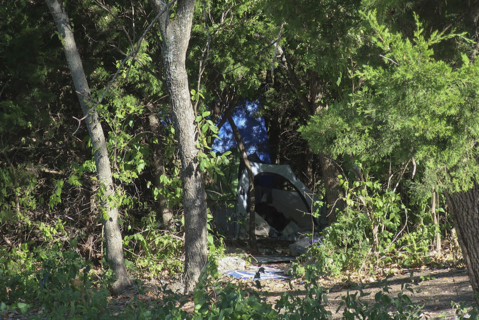 A tent sits in a grove of trees on a wooded lot amid businesses in Topeka, Kan., Thursday, Oct. 5, 2023. Neighbors suspect Zoey Felix, 5, Mickel Cherry and Zoey's father were living there, although police haven’t confirmed that. Cherry, a homeless man, has been charged with the murder and rape of Felix and could face the death penalty in connection with the girl's death on Monday, Oct. 2. (AP Photo/John Hanna)