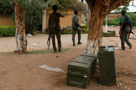 Mutinying soldiers walk next to a box of weapons found after investigation at a residence of a civilian in Bouake, Ivory Coast, May 15, 2017. REUTERS/Luc Gnago