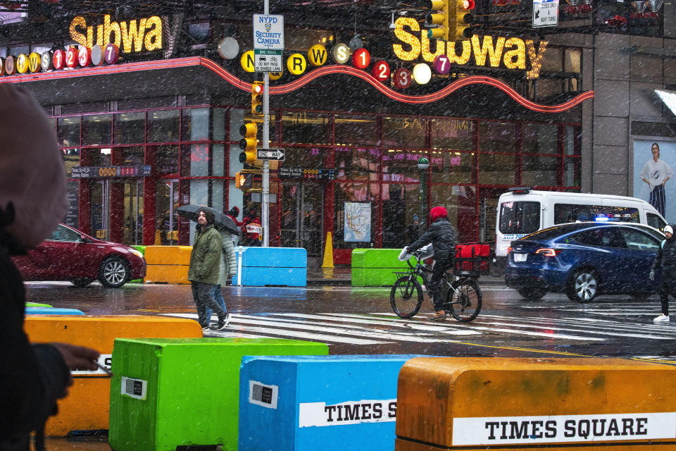 People walk around Times Square during a winter storm in New York, Sunday, Jan. 7, 2024. (AP Photo/Eduardo Munoz Alvarez)