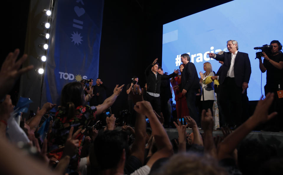 Peronist presidential candidate Alberto Fernández points to supporters after incumbent President Mauricio Macri conceded defeat at the end of election day in Buenos Aires, Argentina, Sunday, Oct. 27, 2019. (AP Photo/Natacha Pisarenko)