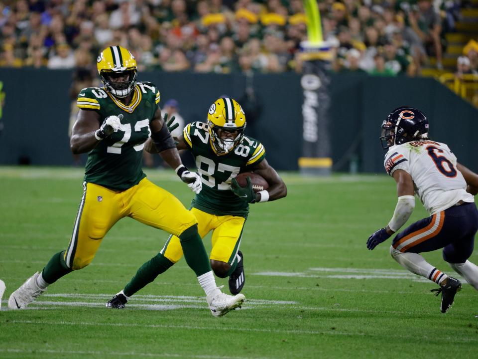 Romeo Doubs runs with the ball against the Tampa Bay Buccaneers.