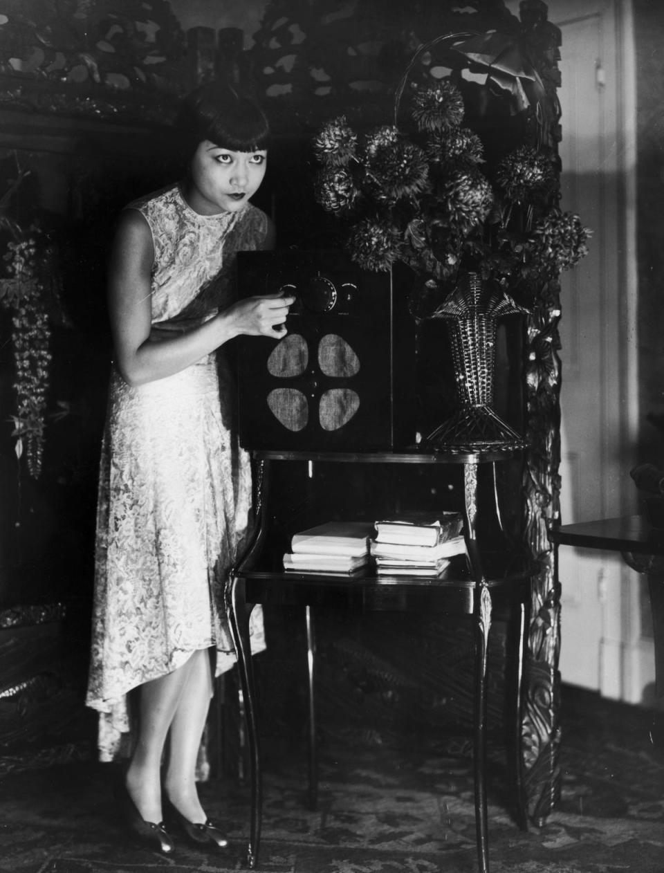 Anna May tunes her wireless set at her flat in London, in 1928 (William Davis/General Photographic Agency/Getty Images)