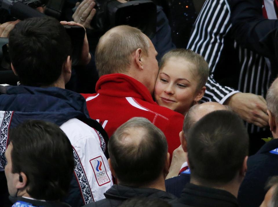 Yulia Lipnitskaya of Russia's figure skating team is greeted Russia's President Vladimir Putin at the Sochi 2014 Winter Olympics, February 9, 2014. REUTERS/David Gray (RUSSIA - Tags: SPORT FIGURE SKATING SPORT OLYMPICS)