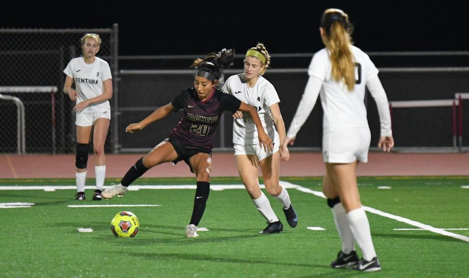 Oxnard's Sienna Pimentel controls the ball while being defended by Ventura's Esja Moore during the Yellowjackets' 3-2 victory in a Pacific View League match earlier this season.