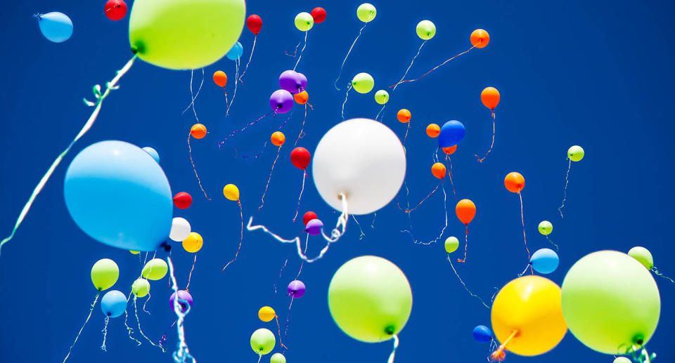 Colourful balloons being released into the sky