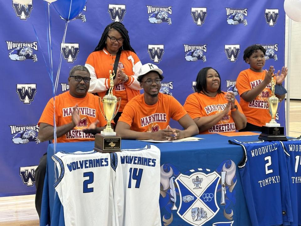 Wes Walker of Woodville-Tompkins with his family as he signed to play college basketball at Maryville College on Wednesday.